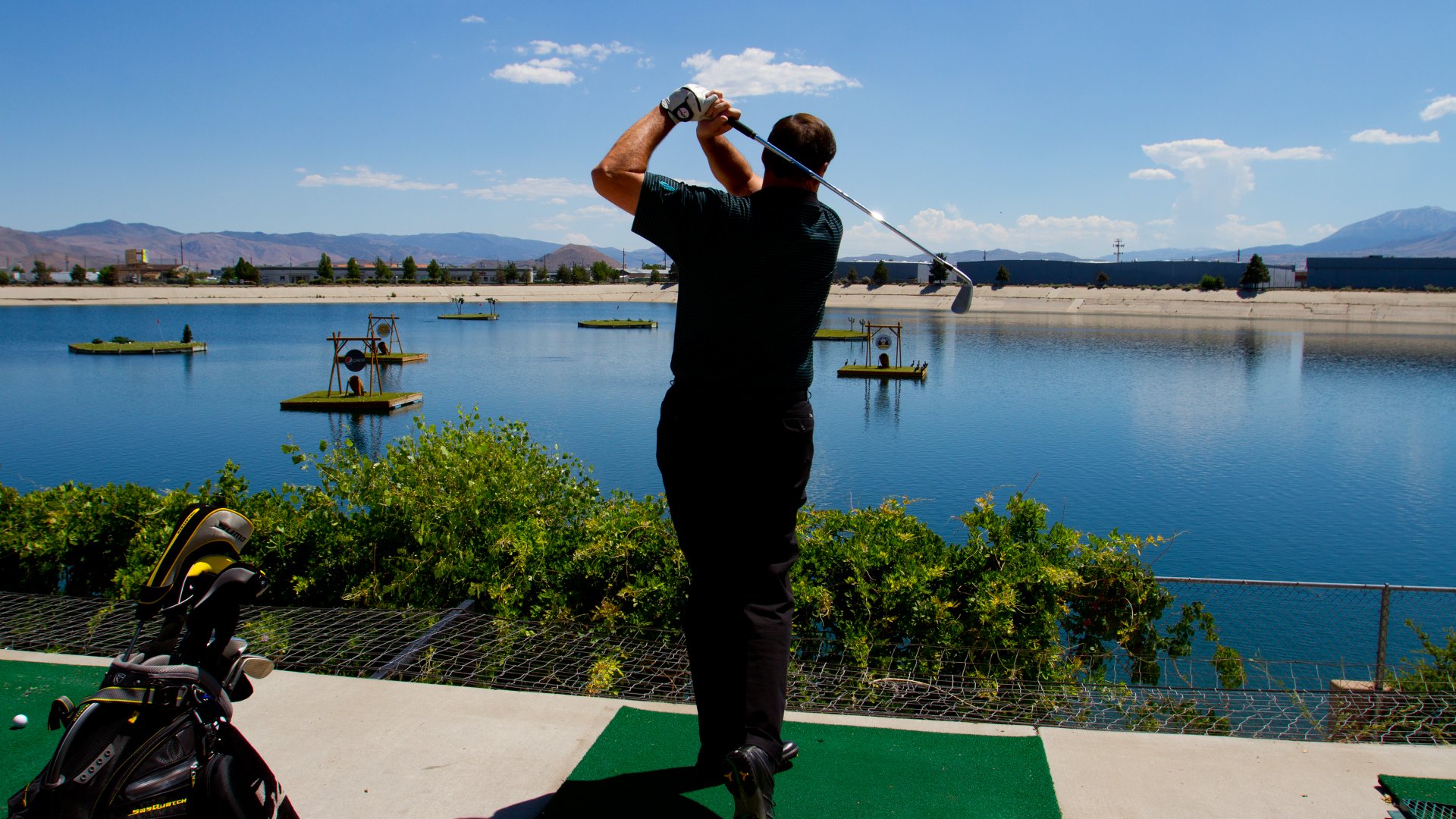Grand-Bay-Driving-Range-view-of-person-completing-swing_q085_1920x1080